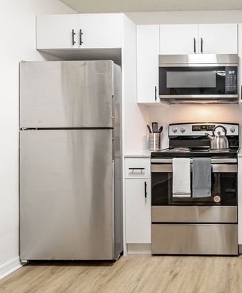 a kitchen with white cabinets and stainless steel appliances  at Northlake Apartments, Jacksonville, FL, 32218